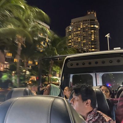 a group of people sitting around a car