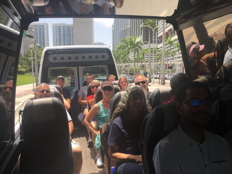 a group of people standing around a bus