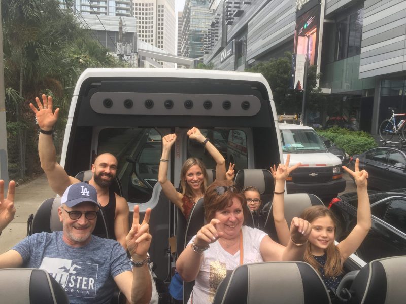 a group of people standing around a bus