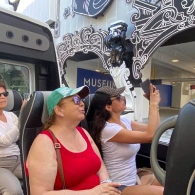 a group of people sitting around a car