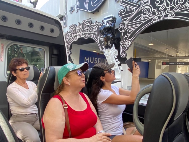 a group of people sitting around a car