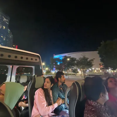 a group of people standing in front of a bus