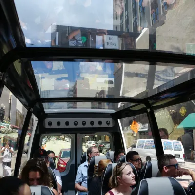 a group of people sitting at a bus stop