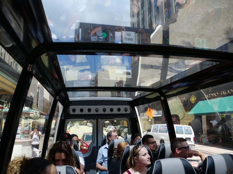 a group of people sitting at a bus stop