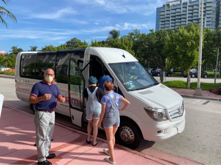 a group of people standing in a parking lot