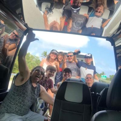 a group of people sitting around a car