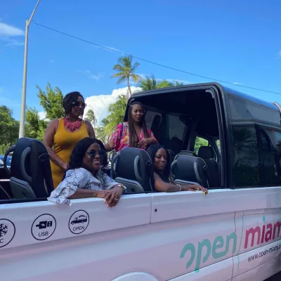 a group of people riding on the back of a truck