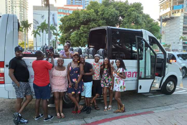 a group of people standing around a bus