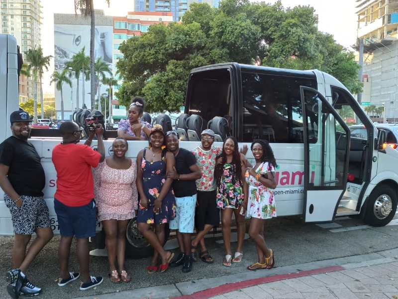 a group of people standing around a bus