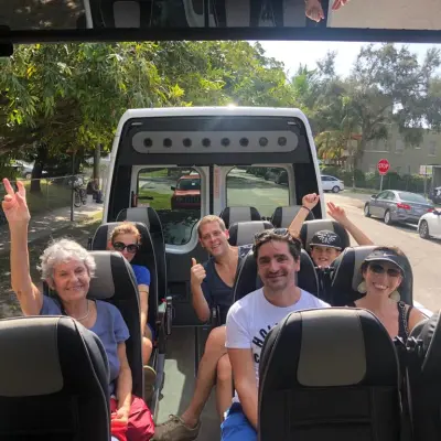 a group of people standing in front of a bus