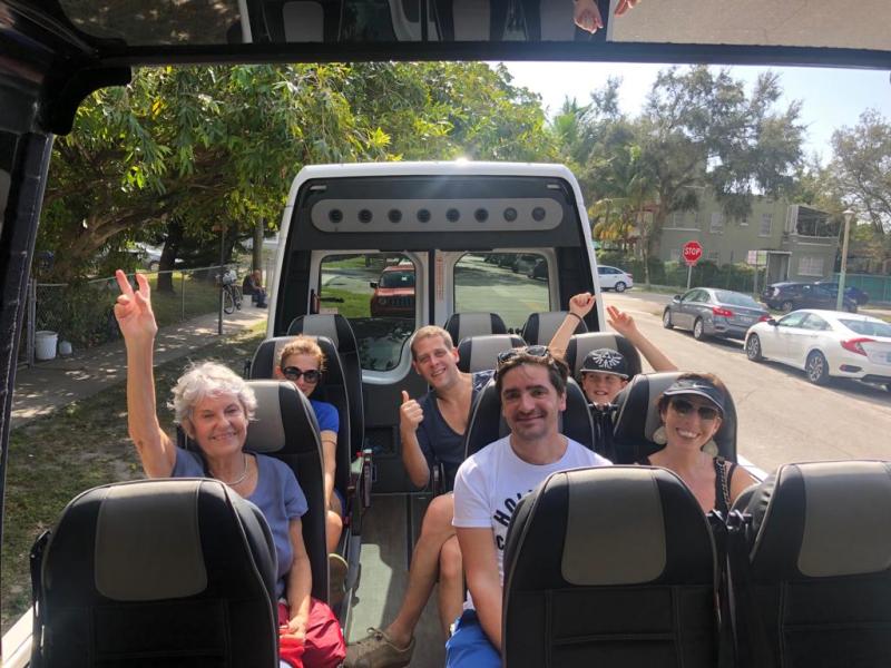 a group of people standing in front of a bus