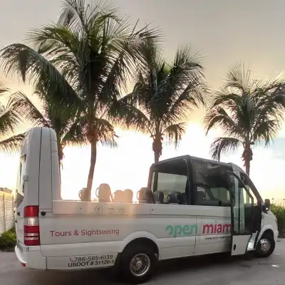 a truck is parked in front of a palm tree