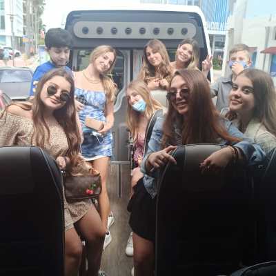 a group of people standing in front of a car
