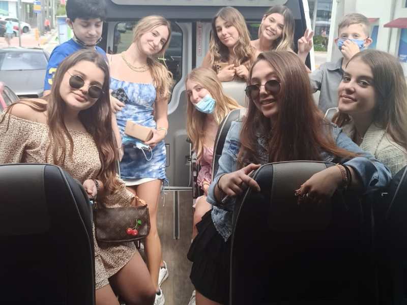 a group of people standing in front of a car