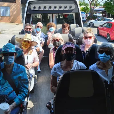 a group of people riding on the back of a car
