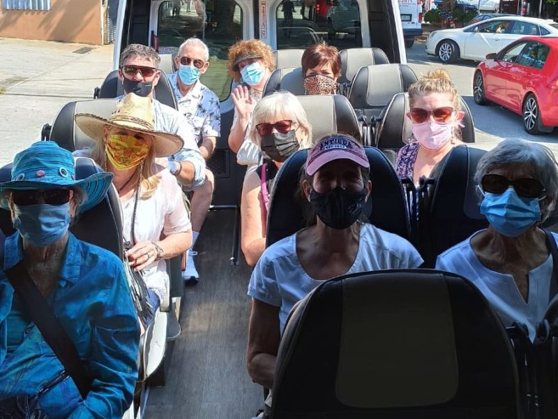 a group of people riding on the back of a car