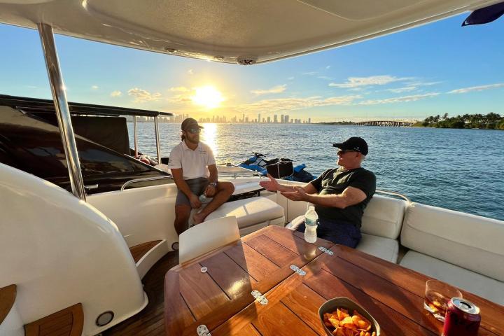 a group of people sitting on a boat in the water