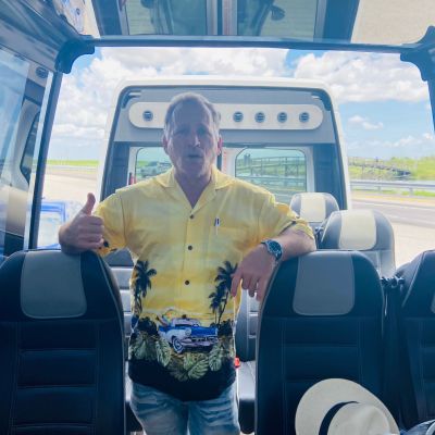 a man sitting in a car posing for the camera