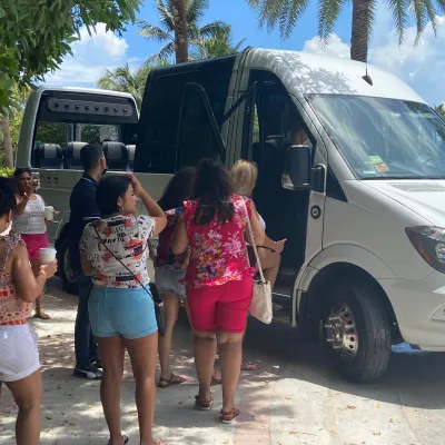a group of people standing in front of a bus