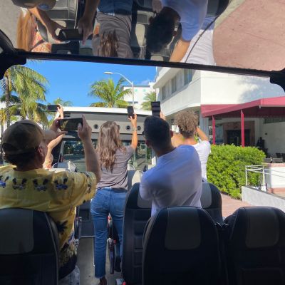 a group of people standing around a bag of luggage