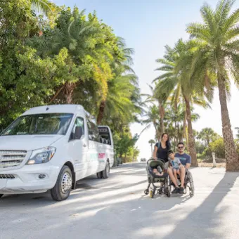 a man riding a skateboard down a street next to a palm tree