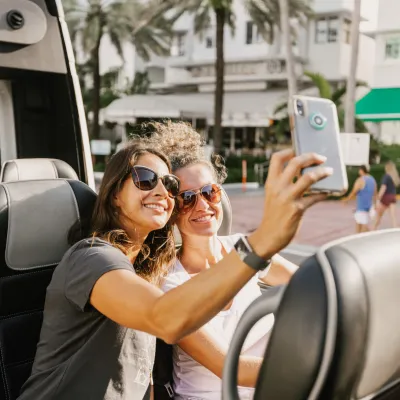 a person in a car talking on a cell phone