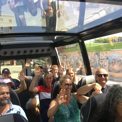 a group of people standing in front of a crowd posing for the camera