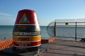 a bottle of water with Southernmost point buoy in the background